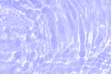 Water surface. Purple water waves on the surface ripples blurred. Defocus blurred transparent blue...