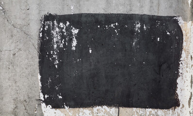 Concrete wall background with black stain of paint. Grunge concrete wall texture. Abstract wallpaper.