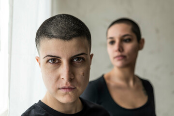 Tattooed women indoors, Milano, Italy.