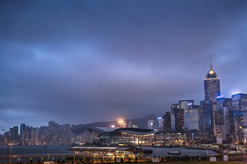 Hong Kong architecture at night with cloudy skies.