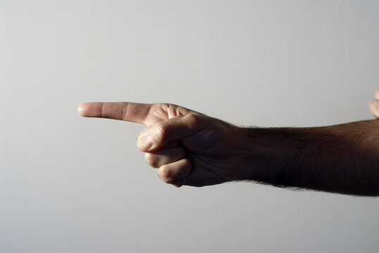 Adult man grimacing with his face and gesturing with his hands