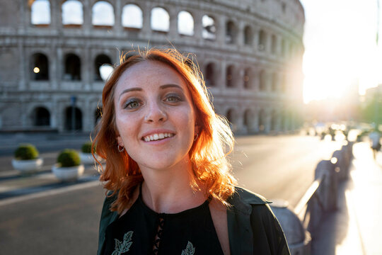 Young woman with red hair, near Colluseum, Rome, Italy