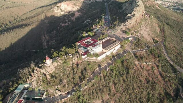 Stunning drone footage capturing the Cerro de la Bufa's side by the cable car, gradually approaching the mountain while lowering to a breathtaking zenithal view
