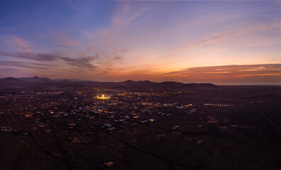 Obraz premium Spectacular sun set image over Lajares village against the setting sun and skyscape near Corralejo, Fuerteventura, Canary Islands, Spain