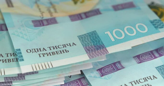 Money of Ukraine. Ukrainian banknotes of max denomination. New banknotes 1000 Hryvnia in uncirculated condition, UNC. Real Ukrainian paper money of blue yellow color, UAH. Cinema 4K 60fps video