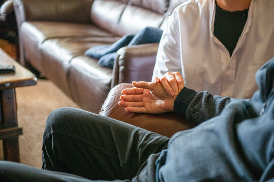 Assisted living nurse taking elderly mans blood pressure with mobile phone