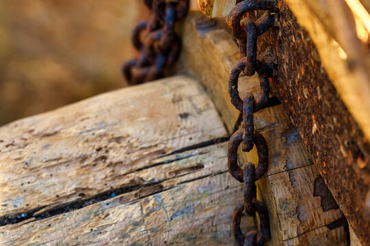 Rusty chain and part of a wooden ancient cart, Asturias, Spain