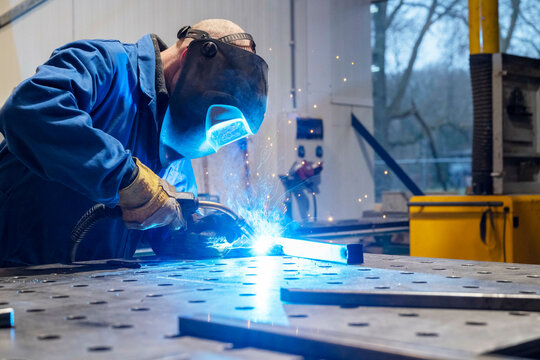 Man welding metal together for a client - Powered by Adobe