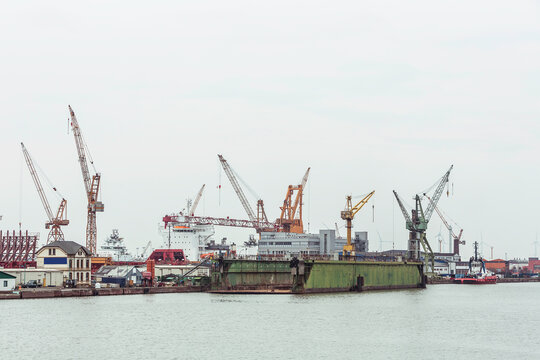 Industrial ships and cranes in a harbor. Bremerhaven, Germany