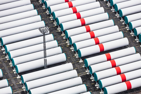 Aerial image of wind turbine parts stacked in container port being ready to ship. Bremerhaven, Germany
