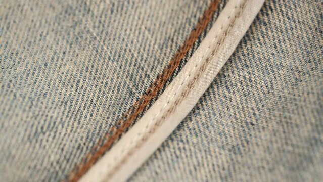 jeans from the inside. close up rotation of the carefully crafted inner seam of jeans. the wrong side of the denim.