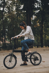 Happy Asian young woman walk and ride bicycle in park, street city her smiling using bike of transportation, ECO friendly, People lifestyle concept.