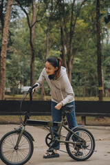 Happy Asian young woman walk and ride bicycle in park, street city her smiling using bike of transportation, ECO friendly, People lifestyle concept.