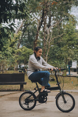 Naklejka premium Happy Asian young woman walk and ride bicycle in park, street city her smiling using bike of transportation, ECO friendly, People lifestyle concept.