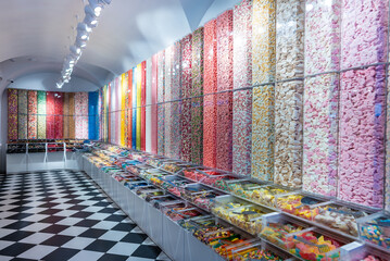 showcase of candy shop, transparent container with various sweets, marshmallow, jelly, chewy gums, rich sugar assortment