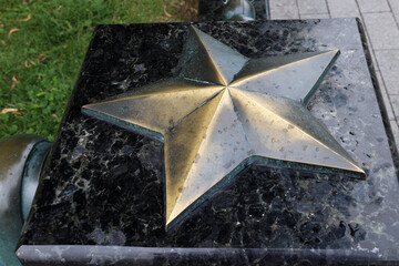 Copper star on a marble base in the park