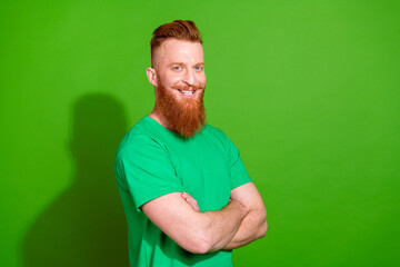 Photo of good mood cheerful man dressed t-shirt arms crossed empty space isolated green color...