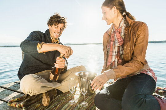 Man proposing to a woman at a romantic location on a lake. Starnberg, Germany