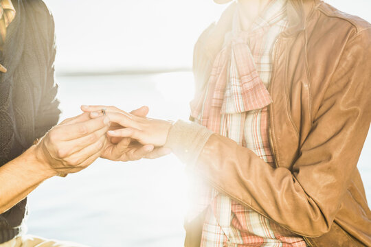 Man proposing to a woman at a romantic location on a lake. Starnberg, Germany