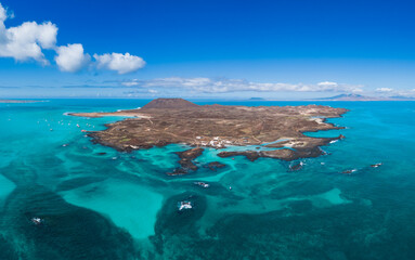 Aerial panoramic landscape view of the beautiful secluded tropical looking natural bay and the island Isla de Lobos near Corralejo, Fuerteventura,  Canary Islands, Spain