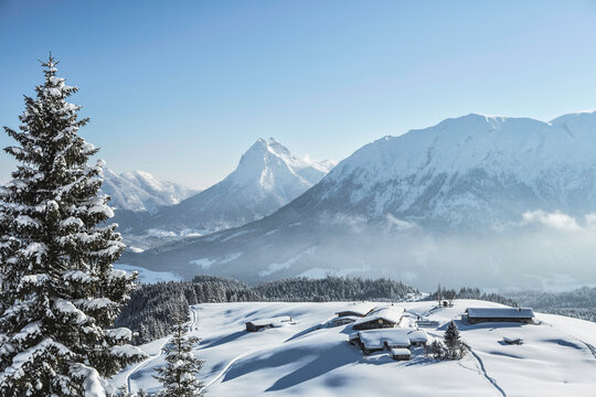 Winter mountain landscape with snowy peaks and trees. Achenkirch, Austria