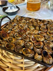 Typical dish of snails a la llauna, usually made in Catalonia, Spain. delicious product accompanied by spicy mayonnaise