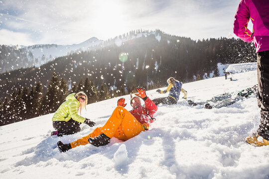 Group of friends having fun in snowy mountains in winter. Achenkirch, Austria 