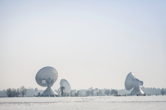 Uplink satellite station in winter landscape with snow and blue skies. 