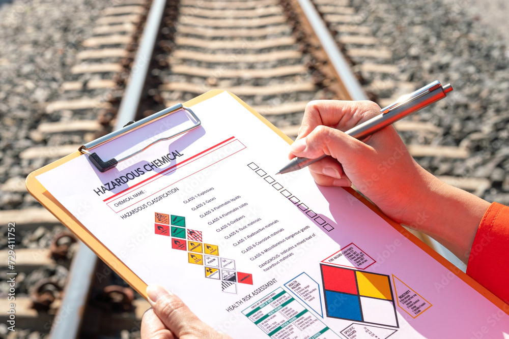 Wall mural action of an engineer is checking on chemical hazardous material checklist form with background of t