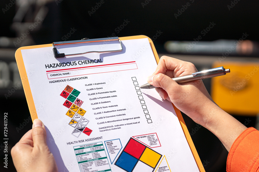 Wall mural action of an engineer is checking on chemical hazardous material checklist form with background of t