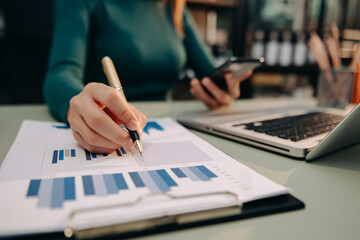 Confident businesswoman working on laptop,tablet and smartphone at her workplace at office.