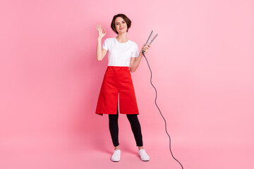 Full length body size photo of hairdresser keeping curler showing okay gesture isolated on pastel pink background