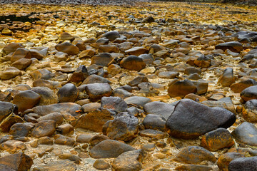 Sulfuric Terrain and Riverbed Rocks at Rio Tinto