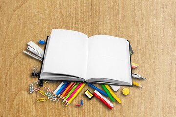 Notebook, pen, colored pencil on light background