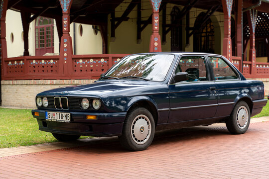 BMW 3 (E30) in blue color is parked in Palic Park, Subotica, Serbia, 02.07.2023 