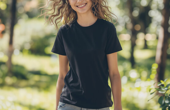 Black short sleeves T-shirt mockup on a young girl, park and nature background summer