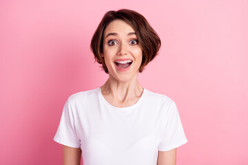 Photo portrait of amazed girl bob hairstyle smiling overjoyed isolated on pastel pink color background