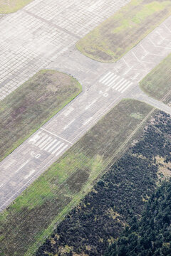 Aerial view of an abandoned runway at small airport.