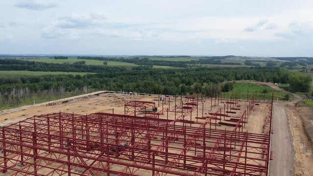 View of the construction site of a large factory in the countryside, filming an aerial video