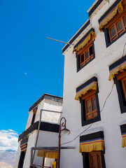 Fototapeta na wymiar Old buildings in Tibetan architecture style of Namgyal Tsemo Gompa Monastery, window color attractively contrast against white wall. 