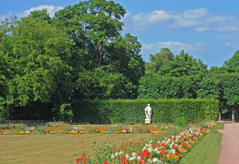 Fototapeta na wymiar Part of the beautiful green park in Fulda, Hessen, Germany (schlossgarten) with blue sky and fluffy white clouds on a summer afternoon