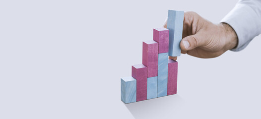 Businessman building a successful financial graph