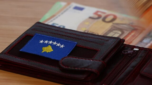 Kosovo euro, Kosovo's entry into the euro zone, financial concept, counting euros on the background of a wallet with the symbol of Kosovo, the economy of the country