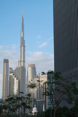 Fototapeta premium Futuristic and modern commercial and residential highrise tower skyscraper architecture with glass facades and clean lines in downtown Dubai, United Arab Emirates for millionaires and high society