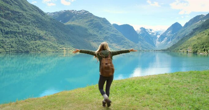 Mountains, nature or happy woman in outdoor vlog online on social media on a holiday vacation. Smile, influencer or excited person hiking in Norway to travel for recording, video or live streaming