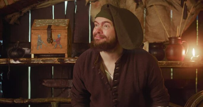 Bartender leaves work to listen customer in tavern. Attentive man with beard takes order from honorable guest in medieval inn. Fantasy role play game