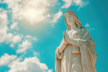 Fototapeta premium Statue of Our lady of grace virgin Mary with Bright Blue Sky
