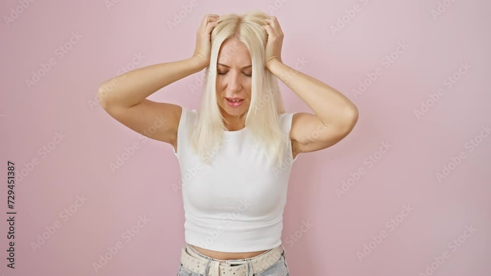 Poster stressed young blonde woman standing over isolated pink background, a picture of suffering with a pi