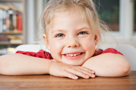 young child smiling in the camera.