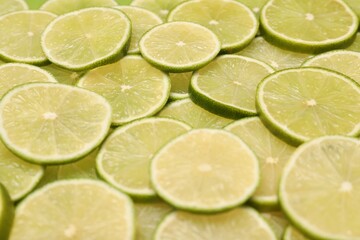 Many juicy lime slices as background, closeup view